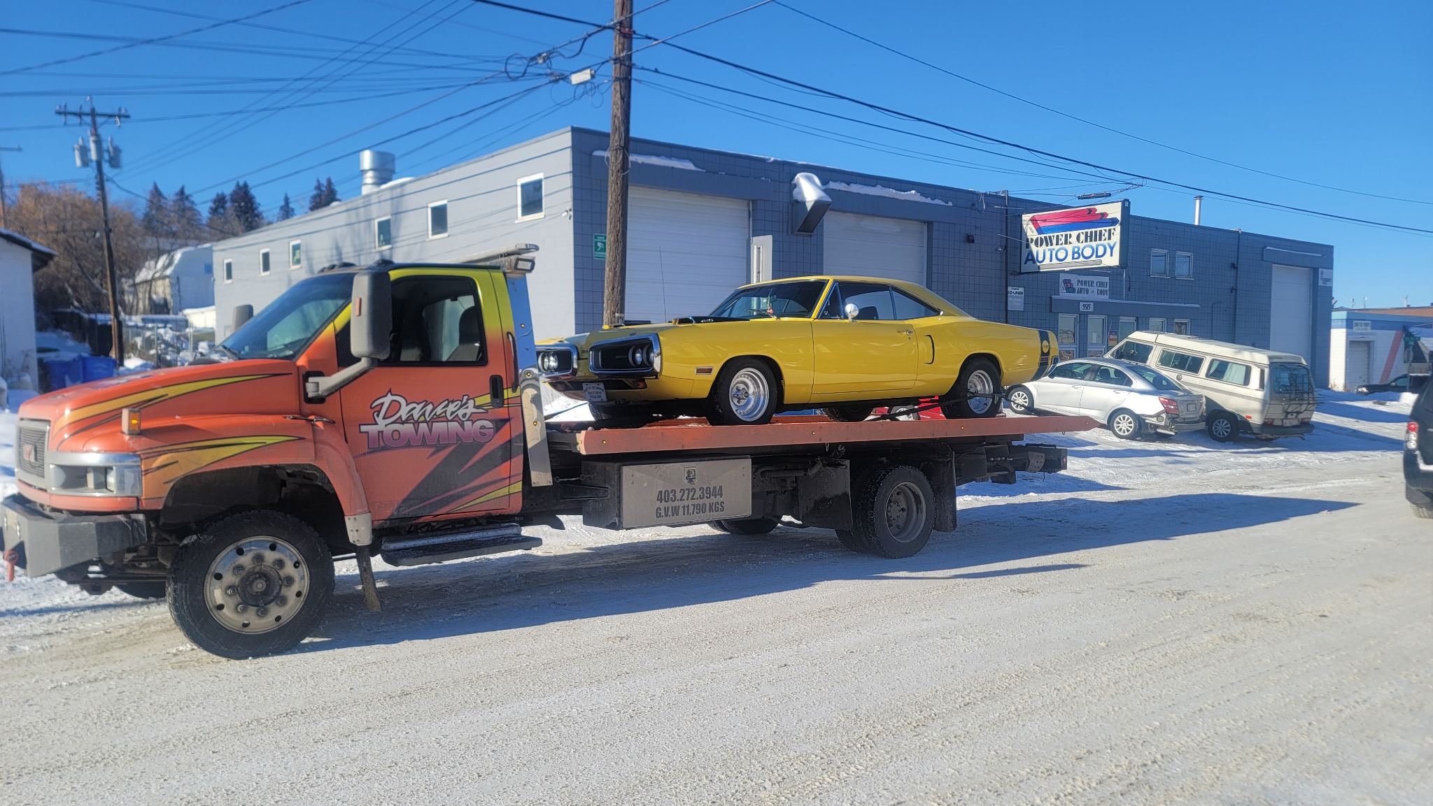 Yellow muscle car on flatbed truck in Calgary